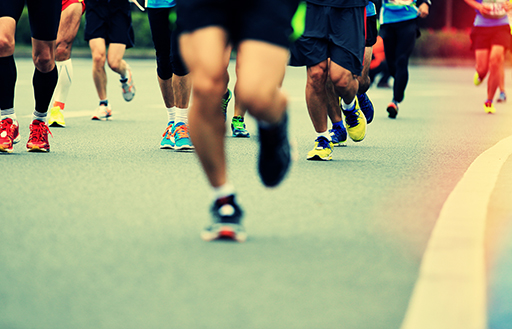 marathon runner legs running on street